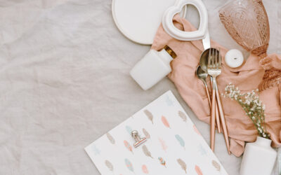 Flat lay Wedding or festive table setting. Plates and cutlery with gray decorative textile on white background. Beautiful arrangement.