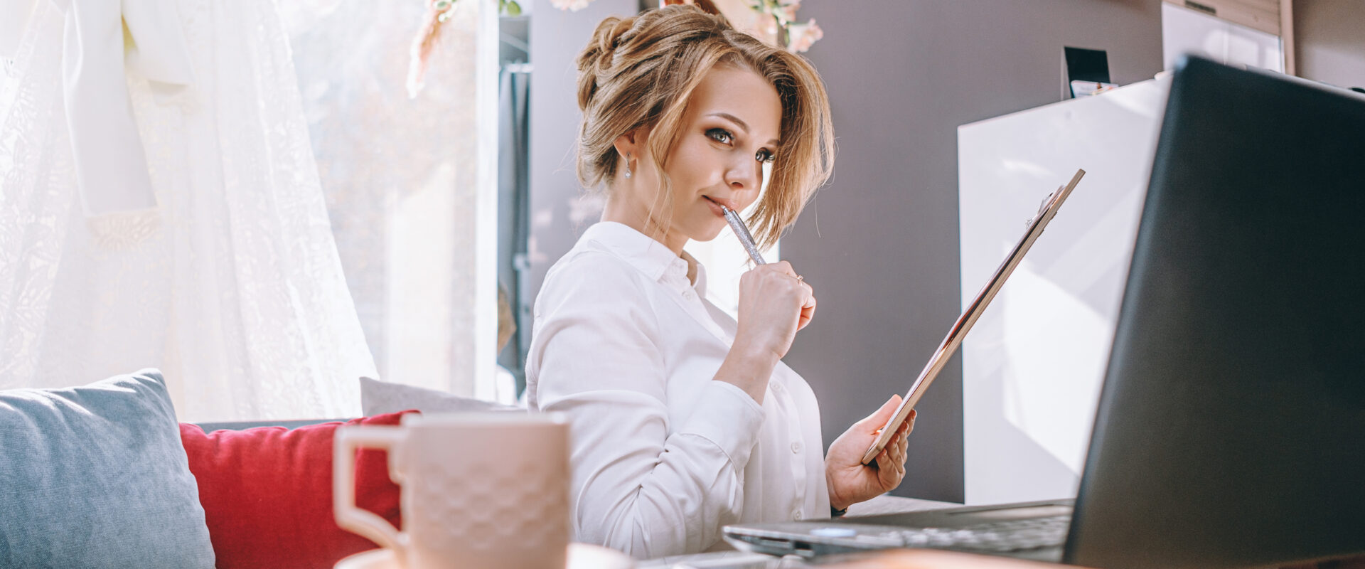 young woman wedding planner in office with laptop and tablet for writing